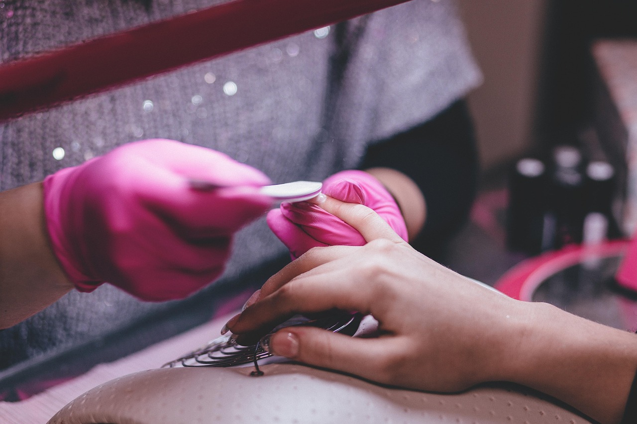 A nail technician filing a client's nails